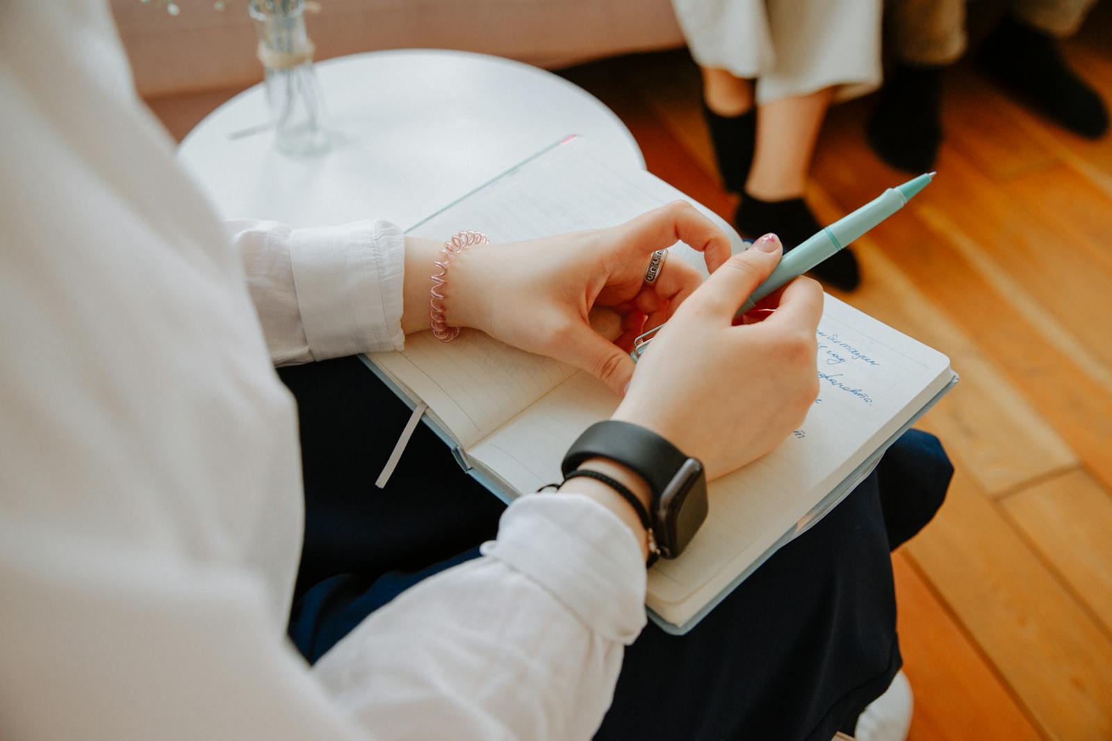 A person taking notes during a counselling session
